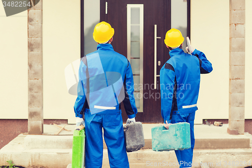 Image of group of builders with toolboxes