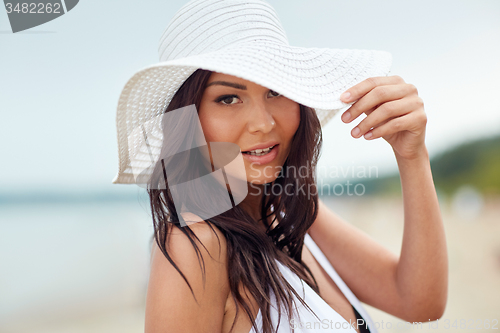 Image of happy young woman on beach