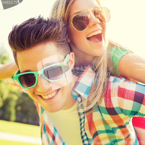 Image of smiling couple having fun in park