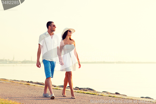 Image of smiling couple walking outdoors