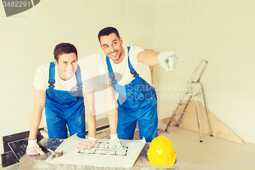 Image of group of builders with blueprint