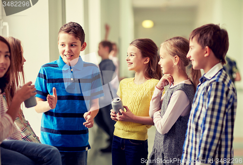 Image of group of school kids with soda cans in corridor