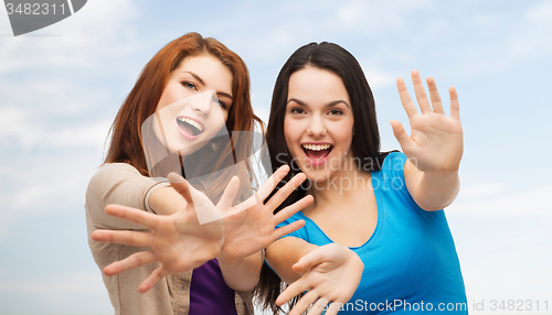 Image of smiling teenage girls having fun