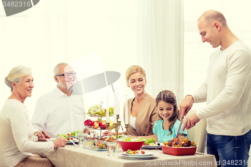 Image of smiling family having holiday dinner at home