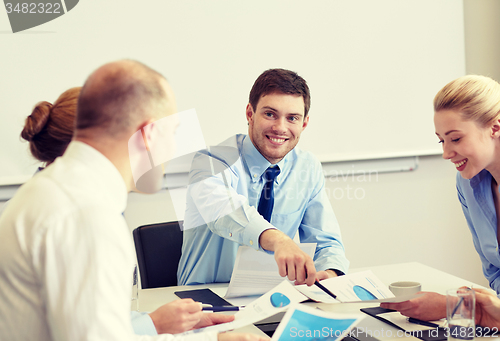 Image of business people with papers meeting in office