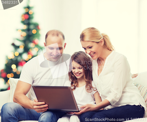 Image of happy family with laptop computer