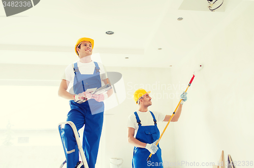 Image of group of builders with tools indoors