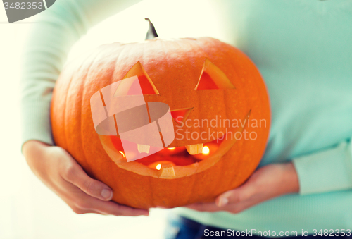 Image of close up of woman with pumpkins at home