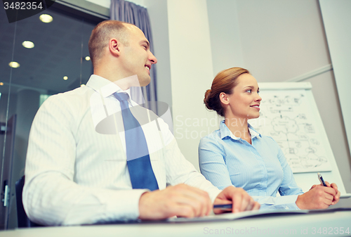 Image of smiling business people meeting in office