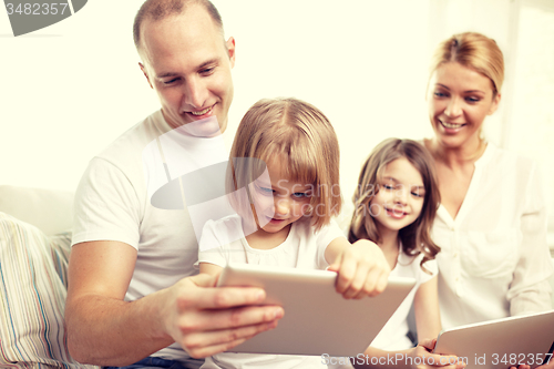 Image of happy family with tablet pc computers at home