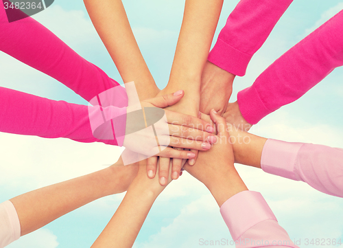 Image of close up of women with hands on top