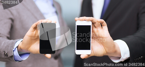 Image of businessman and businesswoman with smartphones