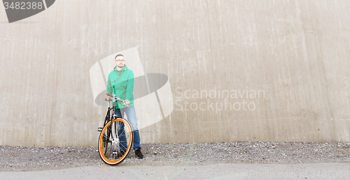 Image of happy young hipster man with fixed gear bike