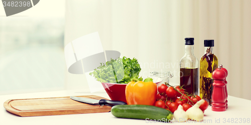 Image of vegetables, spices and kitchenware on table