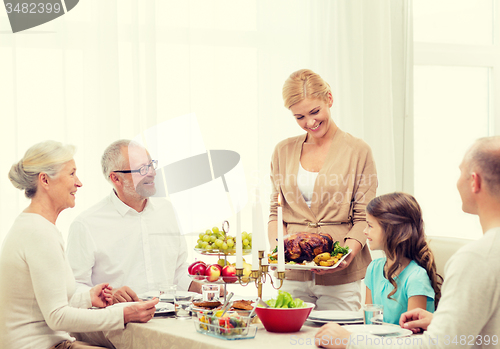 Image of smiling family having holiday dinner at home