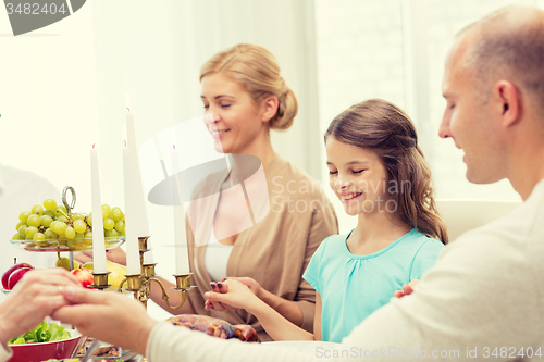 Image of smiling family having holiday dinner at home