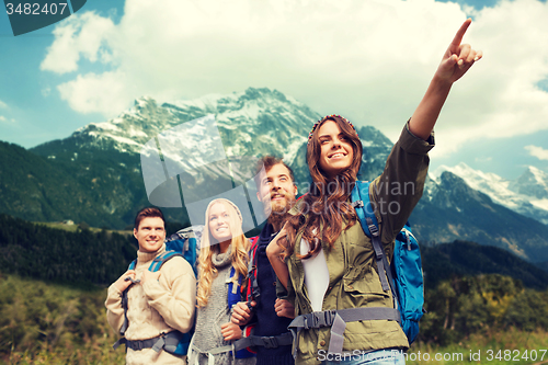 Image of group of smiling friends with backpacks hiking