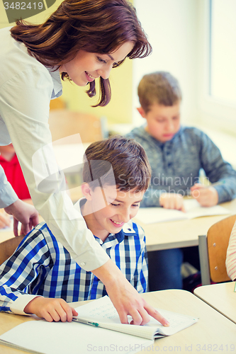 Image of group of school kids writing test in classroom