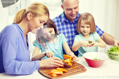 Image of happy family with two kids cooking at home