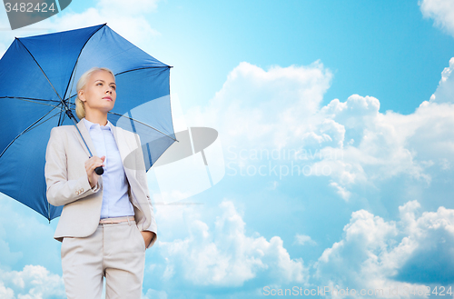 Image of young smiling businesswoman with umbrella outdoors