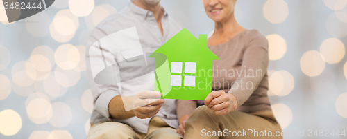 Image of close up of happy senior couple with green house