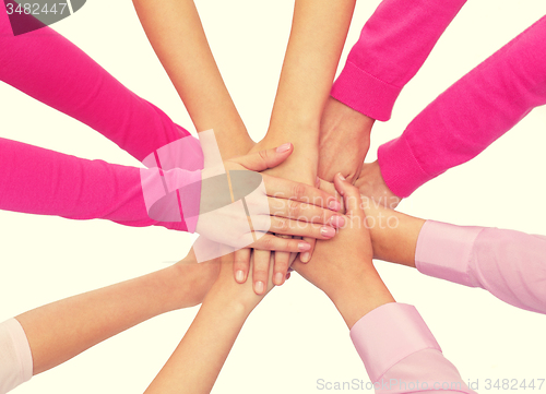 Image of close up of women with hands on top