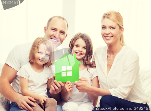 Image of smiling parents and two little girls at new home