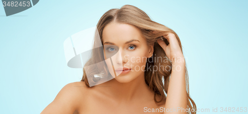 Image of beautiful young woman face over blue background