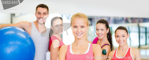 Image of woman standing in front of the group in gym