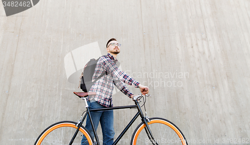 Image of hipster man with fixed gear bike and backpack