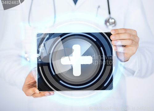 Image of male doctor holding tablet pc with medical app