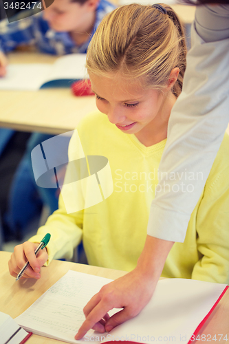 Image of group of school kids writing test in classroom