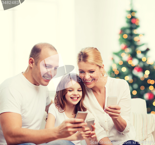 Image of happy family with smartphones