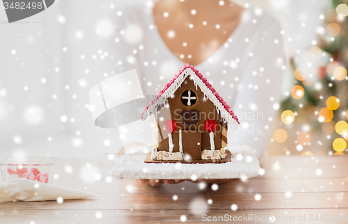 Image of close up of woman showing gingerbread house