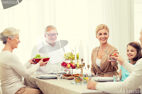 Image of smiling family having holiday dinner at home