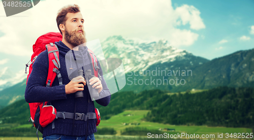 Image of man with backpack and binocular outdoors