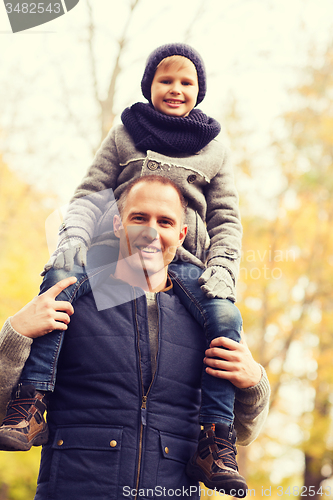 Image of happy family having fun in autumn park