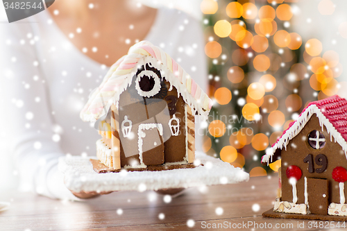 Image of close up of woman showing gingerbread house
