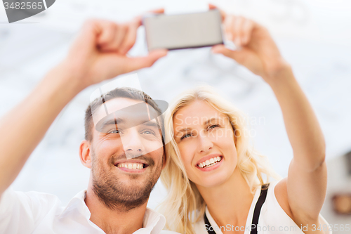 Image of happy couple taking selfie with smartphone 
