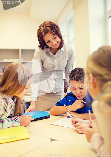 Image of group of school kids writing test in classroom