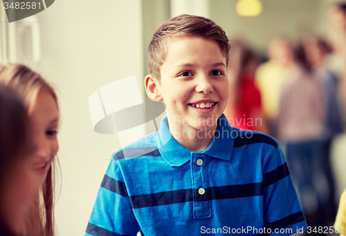 Image of group of smiling school kids in corridor