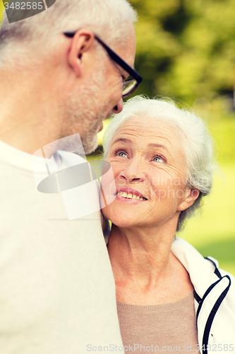 Image of senior couple hugging in city park