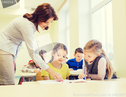 Image of group of school kids writing test in classroom