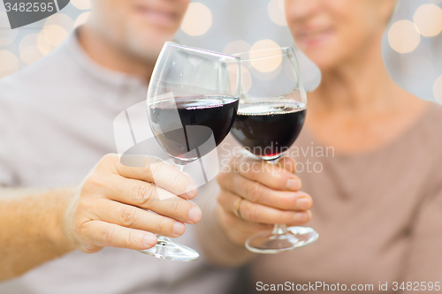 Image of close up of happy senior couple with red wine