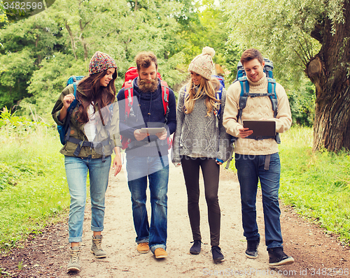 Image of group of friends with backpacks and tablet pc