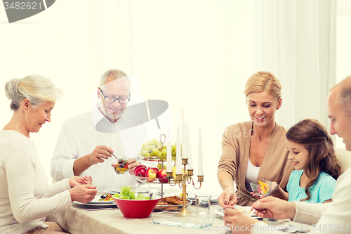Image of smiling family having holiday dinner at home