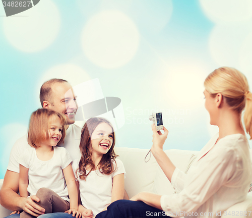 Image of happy family with camera at home