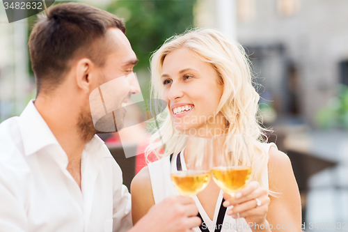 Image of happy couple clinking glasses at restaurant lounge