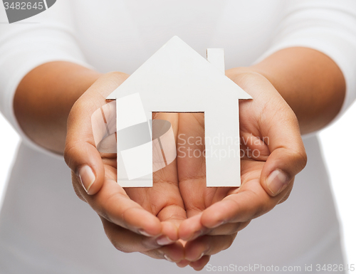 Image of woman hands with paper house