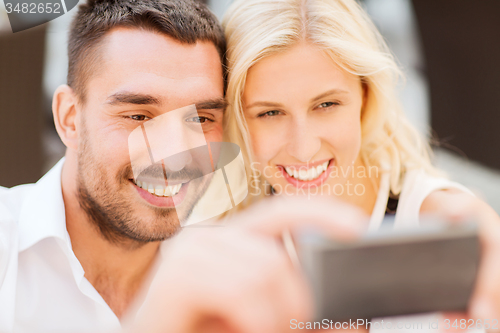 Image of happy couple taking selfie with smartphone 